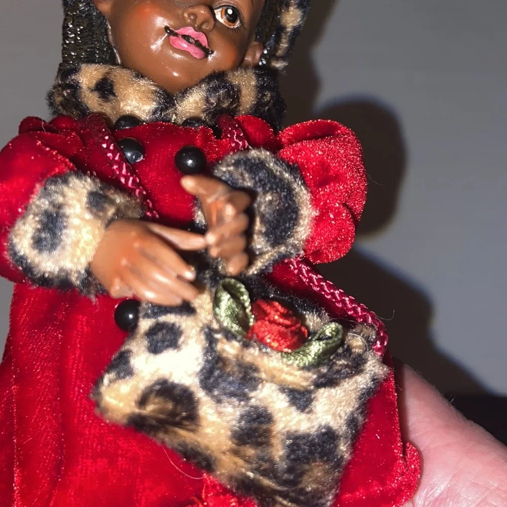 Vintage African American doll ornament with red velvet and leopard fur purse